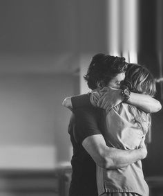 black and white photograph of two people hugging each other