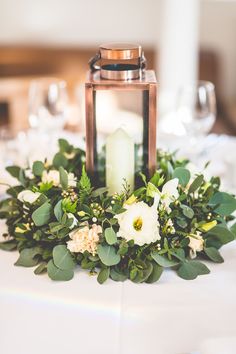 two pictures of a table with flowers and candles on it, one has a candle in the middle