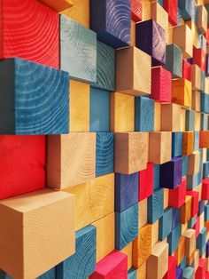 colorful wooden blocks are arranged on the wall in this art work, which is made from wood