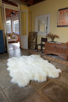 a large white sheepskin rug on the floor in a living room