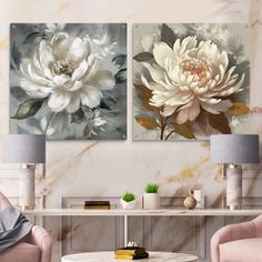 two white flowers are on the wall in this living room