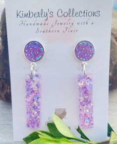 the earrings are made with purple and pink glitter