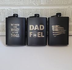 three black flasks with the words dad fuel and american flag painted on them