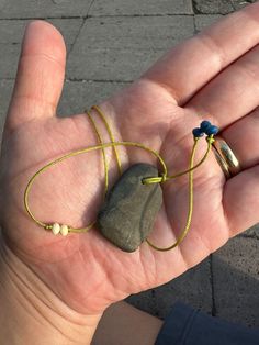 Discover the natural beauty of the beach with our Handmade Sea Pebbles Necklace. Each unique pebble is carefully selected from the shore, giving you a one-of-a-kind piece that connects you to the earth. 
          This rock necklace features smooth, organic stones that are polished by nature and hand-crafted into a beautiful beach pebble pendant. Perfect for anyone who loves minimalist, earthy, or eco-friendly jewelry, our stone necklace is a versatile accessory that complements any outfit. Crafted with care, our pebble jewelry reflects the timeless beauty of the coast. 

           Order today and enjoy your necklace which is completely natural and one of a kind! Rock Necklaces, Pebble Jewelry, Pebble Pendant, Pebble Necklace, Beach Pebbles, Rock Necklace, Stone Jewellery, Unisex Necklace, Eco Friendly Jewelry