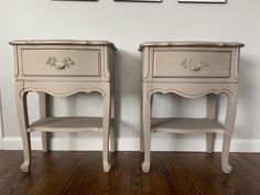 two white nightstands sitting next to each other on top of a hard wood floor