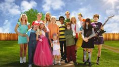 a group of people dressed in costumes posing for a photo