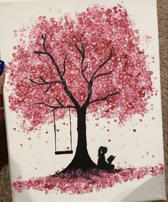 someone is painting a tree with red leaves