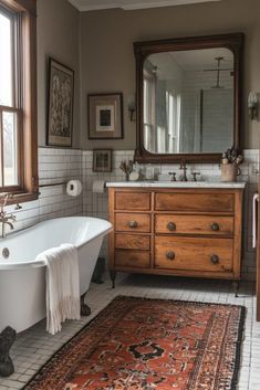 a bathroom with a rug, sink and bathtub next to a large mirror on the wall