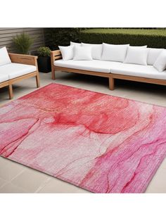 a red and pink rug sitting on top of a patio