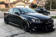 a black car parked in front of a house