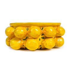 a bunch of yellow lemons sitting on top of each other in front of a white background