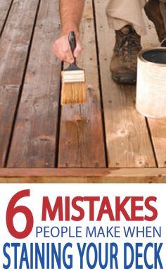 a man is painting the deck with paint