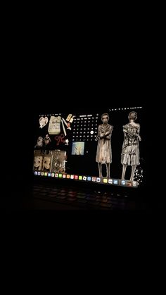 an image of a computer screen that has some pictures on it and is lit up in the dark