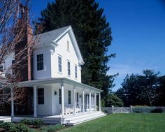 an image of a white house with trees in the background