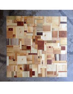 a piece of wood that has been cut into squares with different colors and shapes on it