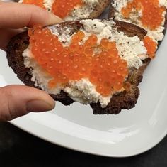 there is a piece of bread with cream and red cavias on it in the shape of hearts