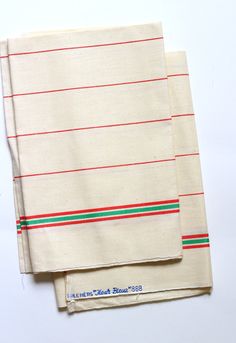 two pieces of cloth with red, green and blue stripes on them sitting next to each other