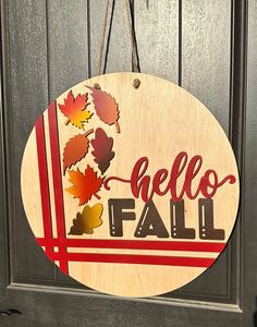 a wooden sign that says hello fall hanging on a door