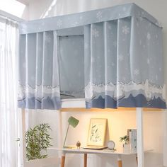 a blue and white bed with curtains over it