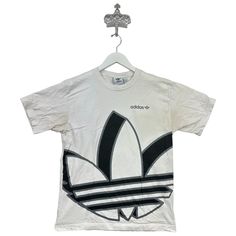 Recommended size: Medium  With discoloration/staining    Great Condition  ★ Era: 2000s MEASUREMENTS: Pit to Pit: 19 in Top to Bottom: 25 in Affordable Adidas Graphic Tee, Adidas Graphic Tee For Streetwear, White Y2k Shirt For Streetwear, White Y2k Style Shirt For Streetwear, 90s Style White Streetwear Shirt, White Bleached Tops For Streetwear, White Bleached Top For Streetwear, Birthday List, Print Tee