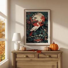 a painting hanging on the wall above a dresser in a room with pumpkins and other decorations