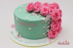 a green cake with pink roses on top and congratulations written on the side in white lettering