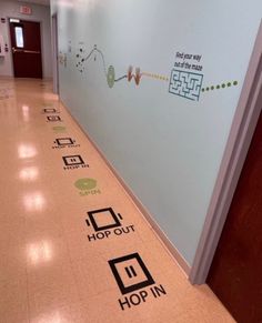 the hallway is lined with stickers that say hop in and hop out on the floor