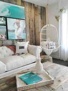 a living room filled with furniture and a birdcage hanging from the wall above it