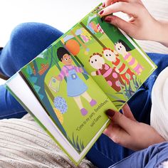 a woman is reading a children's book