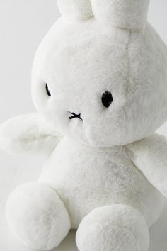 a white stuffed animal sitting on top of a table