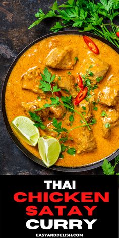 thai chicken satay curry in a pan with limes and cilantro on the side