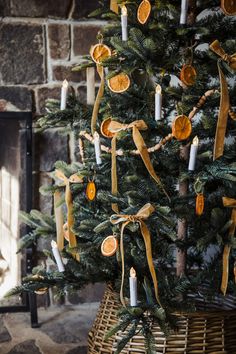 a decorated christmas tree with candles and ribbons