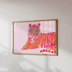 a tiger with sunglasses on it's face is hanging in a white walled room