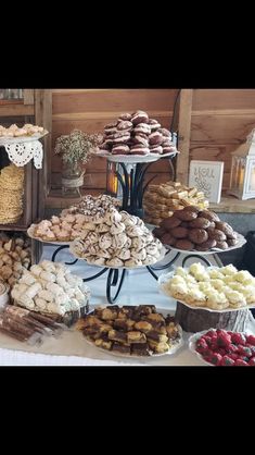 a table topped with lots of different types of pastries and desserts next to each other