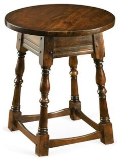 an old wooden table with turned legs and a drawer on the top that has been turned into a side table