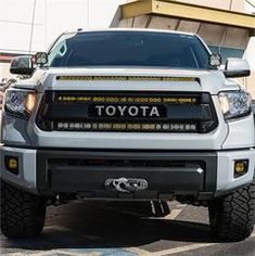 the front end of a white toyota truck