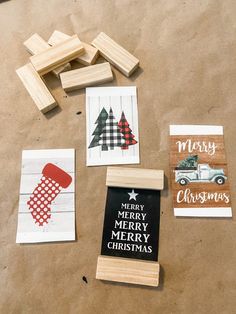 christmas cards and rubber stamps laid out on a piece of brown paper next to wooden blocks