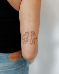 a woman with a horse tattoo on her arm