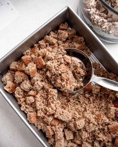 a metal pan filled with food next to a bowl of cereal