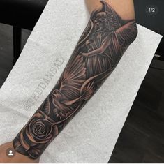 a person with a black and grey tattoo on their arm