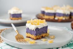 a piece of cake on a plate with a fork next to it and another slice in the background