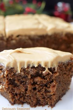 a close up of a piece of cake on a plate with frosted icing