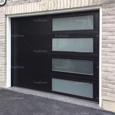 a black garage door with three windows