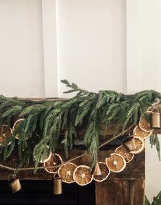 a christmas garland with oranges and pine cones