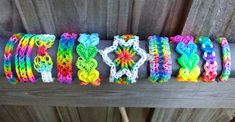 colorful bracelets are arranged on top of a wooden bench with the word hope spelled out