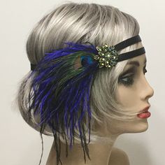 Flapper 1920s headband, Gatsby headband, Black 1920s headpiece, Feather Headpiece, 1920s hair accessory, Vintage inspired This stunning 1920's Vintage Inspired Gatsby headband is the perfect accompaniment for any 1920s styled event. I've designed and created this one-of-a-kind headband so feminine and romantic. Made with two bands of a Satin Black elastic ribbon. This makes the headband self-adjusting.  Accompanied with Black and Royal Blue Ostrich feathers. Featuring a Peacock Eye. I embellishe 1920s Hair Accessories, Flapper 1920s, 1920s Headband, Flapper Headpiece, 1920s Headpiece, Gatsby Headband, 1920s Hair, Flapper Headband, Feather Headpiece