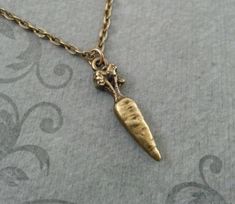 "This listing is for a brass carrot charm necklace. You'll be able to choose your chain length and style at checkout by using the \"Chain Length/Style\" drop-down menu. **Please see the second photo for scale! This is a VERY SMALL charm. If you're on the mobile site, just swipe to the side. :) - - - - - - - This is our third shop for jewelry. If you're looking for something a bit more \"personalized\", then just follow these links: www.etsy.com/shop/metalspeak www.etsy.com/shop/metalspeaktoo - - Carrot Jewelry, Vegetable Necklace, Carrot Necklace, Vegan Gifts, Small Charms, Brass Necklace, Bridesmaid Necklace, Letter Charms, Star Fashion