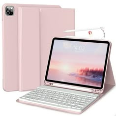 an open laptop computer sitting on top of a white table next to a pink case