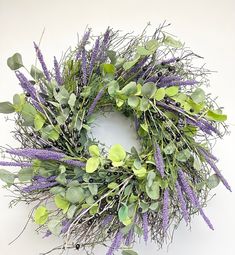 a wreath with purple flowers and green leaves