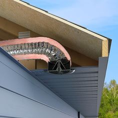 a metal gutter vent on the side of a building